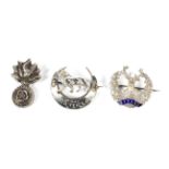 Three silver and white metal military sweetheart brooches.