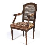 A 19th century Louis XVI style dark stained carved armchair.