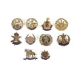 Ten brass and enamel sweetheart cap badges.