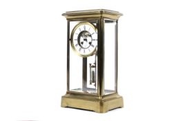 A brass and bevelled glass mantel clock, circa 1900.