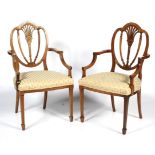 A pair of 20th century Hepplewhite style dining chairs.