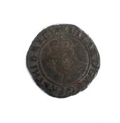 An Elizabeth I shilling coin, slightly bowed.