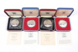 Four silver proof crown coins.