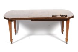 An Edwardian inlaid mahogany wind out dining table.
