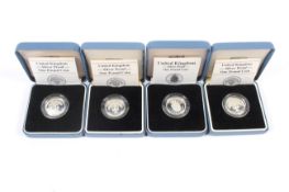 Four £1 silver proof coins.