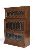 An early 20th century Globe Wernike stained oak glazed three tier bookcase.