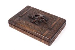An early 20th century carved Black Forest compendium of games with fitted interior.