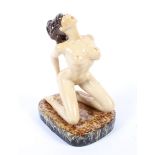 A Peggy Davies sculpture of a nude woman.