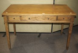 An oak desk with four drawers.