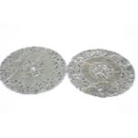 Two carved Chinese mottled green and white hardstone discs.