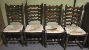 A set of four ladderback cane seat dining chairs.