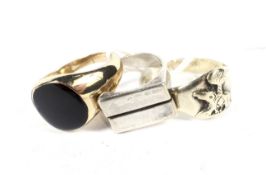 Three white metal and gilt metal signet rings. One with embossed details, 22.