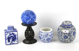 An assortment of Chinese style ceramics. Including ginger jars, tea caddy vase, a candle stick, etc.