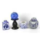 An assortment of Chinese style ceramics. Including ginger jars, tea caddy vase, a candle stick, etc.