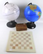 Two contemporary world globes and a vintage chess set.