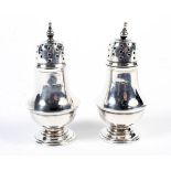 Two Victorian silver pepper shakers.