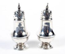Two Victorian silver pepper shakers.