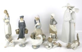 A collection of Lladro and Nao figures. Including nuns, two cats, a cherub, etc max H33cm.