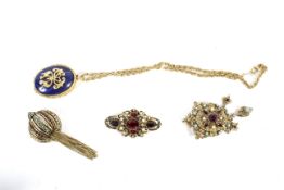 Four Victorian and later costume jewellery brooches and pendants.