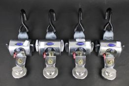 A set of four O'Straint wheelchair clamps.
