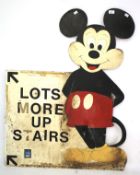 A painted wooden Mickey Mouse sign.