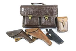 A vintage leather satchel and a selection of leather gun cases.