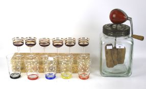 A boxed set of glasses, a set of six tumblers and a butter churn.