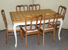 A contemporary extending oak dining table and a set of six chairs.