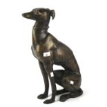 A contemporary bronzed model of a seated greyhound.