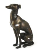 A contemporary bronzed model of a seated greyhound.
