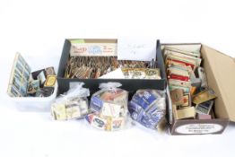 A collection of vintage matchboxes and cigarette cards.