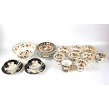 A selection of Imari style teacups and saucers and a bowl.