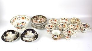 A selection of Imari style teacups and saucers and a bowl.