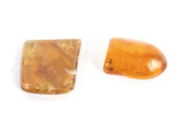 A piece of rounded Baltic amber and a small slab of yellow calcite.