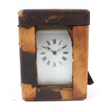 A French brass carriage clock in a fitted leather travelling case.
