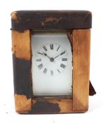 A French brass carriage clock in a fitted leather travelling case.