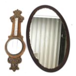 An Edwardian oak mirrored banjo barometer and an oval mirror.