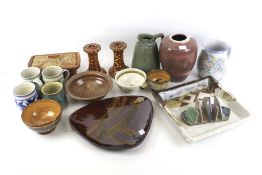 An assortment of studio pottery. Including a pair of candlesticks, mugs, a dish.