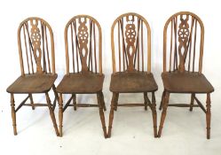 A set of four wheelback kitchen chairs.