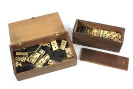 Two vintage ebony and bone domino sets.