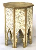 A modern Indian style carved and painted occasional table. Of octagonal form, with floral panels.