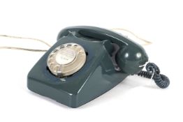 A vintage GPO 746F dark green rotary dial telephone with modern plug.