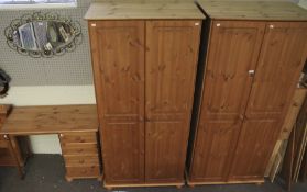 A pair of wardrobes and a contemporary pine dressing table.