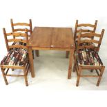 A hardwood extending kitchen table and set of four chairs.