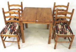 A hardwood extending kitchen table and set of four chairs.