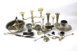 An assortment of silver plate. Including a candlestick, posy vases, a sauceboat, etc.