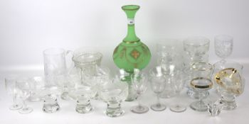 An assortment of glassware. Including drinking glasses, desert dishes, a green vase, etc.
