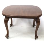 A 20th century mahogany extendable dining table.