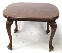 A 20th century mahogany extendable dining table.