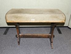 A rustic two plank top oak side table with pegged stretcher.